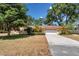 Charming home featuring mature trees, a well-manicured lawn, and a two-car garage at 1190 Pecan St, Kissimmee, FL 34744