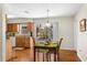Kitchen and dining area featuring wood cabinets, granite countertops, and a view of the pool at 1190 Pecan St, Kissimmee, FL 34744