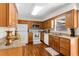Bright kitchen featuring wooden cabinets, granite countertops, and modern appliances at 1190 Pecan St, Kissimmee, FL 34744