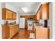 Well-lit kitchen featuring wooden cabinets, granite countertops, and stainless steel appliances at 1190 Pecan St, Kissimmee, FL 34744