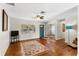 Living room with wood floors, ceiling fan, and a view to the front yard at 1190 Pecan St, Kissimmee, FL 34744