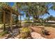 Backyard area with a pergola, brick patio, and lush green foliage at 1190 Pecan St, Kissimmee, FL 34744