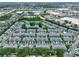 Aerial view of a community with water feature and many homes at 12661 Somerset Oaks St, Orlando, FL 32828