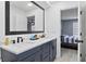 Elegant bathroom with double sinks, modern fixtures, and access to the bedroom at 12661 Somerset Oaks St, Orlando, FL 32828