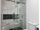 Contemporary bathroom showcasing a glass shower, bench, and matte black fixtures at 12661 Somerset Oaks St, Orlando, FL 32828