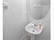 Bathroom with pedestal sink, oval mirror and white color palette at 12661 Somerset Oaks St, Orlando, FL 32828