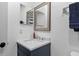 Bright bathroom featuring a navy vanity with a chrome faucet and an accent mirror at 12661 Somerset Oaks St, Orlando, FL 32828