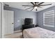 Bedroom featuring ceiling fan, bed, tv, and large window at 12661 Somerset Oaks St, Orlando, FL 32828