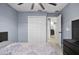 Cozy bedroom featuring soft blue walls, a double door closet, and a ceiling fan at 12661 Somerset Oaks St, Orlando, FL 32828