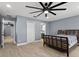 Large bedroom with wood floors, a ceiling fan, and 2 doorways at 12661 Somerset Oaks St, Orlando, FL 32828