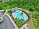 Community pool featuring lounge chairs, mature landscaping, and a nearby treeline at 12661 Somerset Oaks St, Orlando, FL 32828