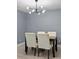Dining area featuring a modern chandelier and neutral color palette at 12661 Somerset Oaks St, Orlando, FL 32828