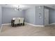 Dining area with wood floors, modern lighting, and neutral color palette at 12661 Somerset Oaks St, Orlando, FL 32828