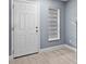 Inviting entryway with white door, wood floors, and natural light from window at 12661 Somerset Oaks St, Orlando, FL 32828
