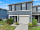 Charming two-story home with a well-maintained lawn and a one-car garage at 12661 Somerset Oaks St, Orlando, FL 32828