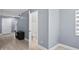 Hallway leading to a bathroom with neutral color palette and tile floors at 12661 Somerset Oaks St, Orlando, FL 32828