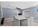 Open floor plan showing the kitchen with white cabinets and stainless steel dishwasher and sink at 12661 Somerset Oaks St, Orlando, FL 32828