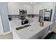 Kitchen with stainless steel appliances, white cabinets, and a large sink with white countertop at 12661 Somerset Oaks St, Orlando, FL 32828