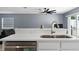 Modern kitchen with stainless steel sink, white cabinets, and quartz countertops at 12661 Somerset Oaks St, Orlando, FL 32828