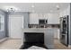 Open floor plan with kitchen featuring white cabinets and stainless steel appliances at 12661 Somerset Oaks St, Orlando, FL 32828