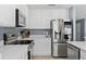 The kitchen features stainless steel appliances and white cabinets for a modern look at 12661 Somerset Oaks St, Orlando, FL 32828