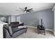 Living room showcases a modern ceiling fan, hardwood floors, and a comfortable black couch at 12661 Somerset Oaks St, Orlando, FL 32828