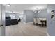 Open-concept space with wood floors seamlessly connects living and dining areas at 12661 Somerset Oaks St, Orlando, FL 32828