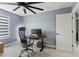 This office space features a modern ceiling fan, white flooring, and a sleek black desk at 12661 Somerset Oaks St, Orlando, FL 32828