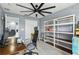 Office space boasting a ceiling fan, white shelving units, and a comfortable work area at 12661 Somerset Oaks St, Orlando, FL 32828