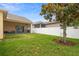 Well-maintained backyard with a covered patio, lush lawn, and a privacy fence for outdoor enjoyment at 1286 Tallow Rd, Apopka, FL 32703