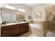 Elegant bathroom with double sinks, a soaking tub, and a glass-enclosed shower at 1286 Tallow Rd, Apopka, FL 32703