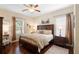 Well-lit bedroom with a king-size bed, wooden furniture, and a ceiling fan at 1286 Tallow Rd, Apopka, FL 32703
