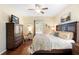 Charming bedroom featuring a decorative bed, natural light, and hardwood floors at 1286 Tallow Rd, Apopka, FL 32703