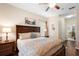 Inviting main bedroom with a decorative bed, ample natural light, and wood flooring at 1286 Tallow Rd, Apopka, FL 32703