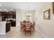 Dining area features wood table set and chandelier lighting, next to a kitchen with dark cabinets at 1286 Tallow Rd, Apopka, FL 32703