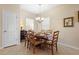 Cozy dining room featuring a round table with seating for six and a charming chandelier at 1286 Tallow Rd, Apopka, FL 32703