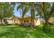Landscaped front yard showcasing a charming one-story home with a cozy covered porch at 1286 Tallow Rd, Apopka, FL 32703
