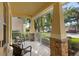 Inviting front porch featuring stone pillars and cozy seating, perfect for relaxing outdoors at 1286 Tallow Rd, Apopka, FL 32703