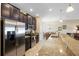 Well-equipped kitchen with granite countertops, stainless steel appliances, and dark wood cabinetry at 1286 Tallow Rd, Apopka, FL 32703