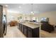 Open kitchen flows into dining and living areas, featuring granite counters and stainless appliances at 1286 Tallow Rd, Apopka, FL 32703