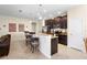 Eat-in kitchen with granite countertops, dark wood cabinets, and stainless steel appliances at 1286 Tallow Rd, Apopka, FL 32703