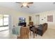 Cozy living room featuring comfortable seating and natural light from the sliding glass door at 1286 Tallow Rd, Apopka, FL 32703