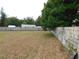 Large, fenced backyard featuring a combination of dead and green grass at 130 Krider Rd, Sanford, FL 32773
