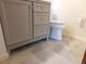 Bathroom featuring a gray vanity with updated silver hardware, toilet, and tile floor at 130 Krider Rd, Sanford, FL 32773