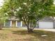 Single-story home with an attached garage and mature landscaping at 130 Krider Rd, Sanford, FL 32773