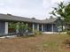 Exterior front view of a single-story home with neutral gray exterior and tidy landscaping at 130 Krider Rd, Sanford, FL 32773
