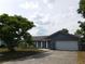 Single-story home with an attached garage and mature landscaping at 130 Krider Rd, Sanford, FL 32773
