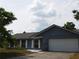 A single-story home with a one-car garage and a well-maintained lawn at 130 Krider Rd, Sanford, FL 32773