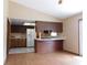 Kitchen with bar top and wood cabinets next to the white refrigerator at 130 Krider Rd, Sanford, FL 32773
