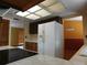 Kitchen with tiled floor with white refrigerator and dark wood cabinets at 130 Krider Rd, Sanford, FL 32773